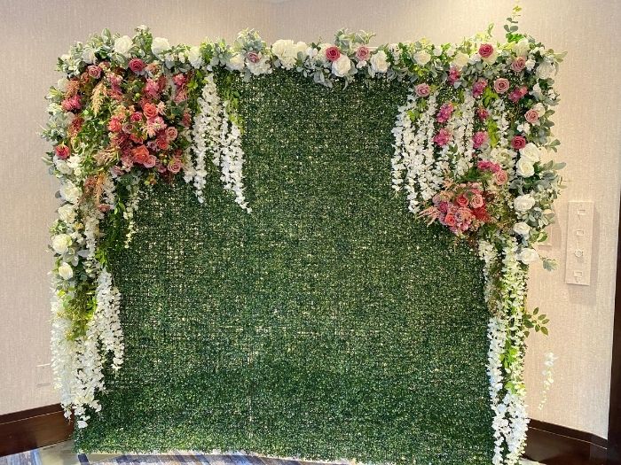 Elegant boxwood backdrop with cascading white wisteria and blush pink roses, available for event and wedding rentals from Simply LaMayed in Northern Virginia.