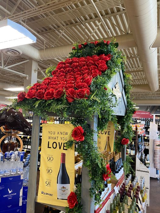 Custom red rose and greenery floral installation designed by Simply LaMayed to enhance a Kendall-Jackson and La Crema wine display for the Kentucky Derby 150th celebration.