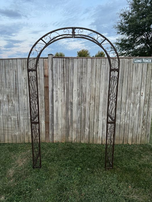Classic outdoor metal arch perfect for floral installations or wedding ceremonies, available through Simply LaMayed Custom Decor.