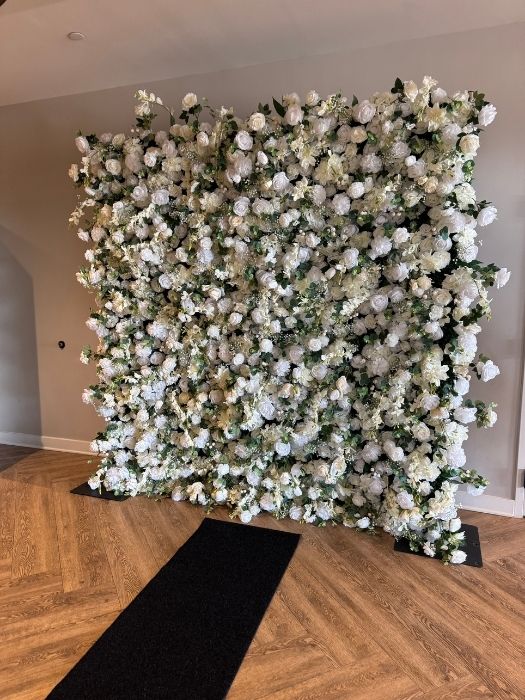 White floral wall backdrop featuring full blooms and greenery, ideal for weddings and special events, available for rent from Simply LaMayed in Northern Virginia.