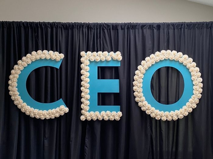 “CEO” event letters outlined with white flowers.